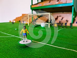 Football figures lined up on a grass field