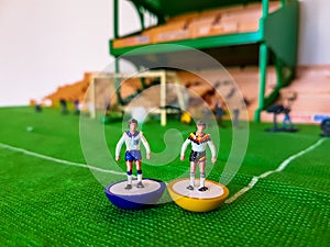 Football figures lined up on a grass field