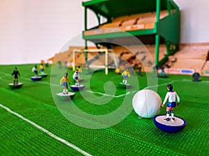 Football figures lined up on a grass field