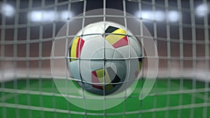 Football with flags of Belgium hits goal net. 3D rendering