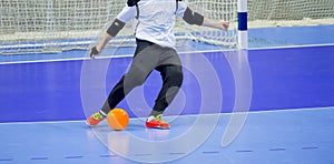 Football Futsal Ball and man Team. Indoor Soccer Sports Hall. goalkeeper with a ball photo