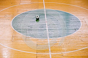 Football or futsal stadium with a bright markup of the playing field and ball in center. Top View.