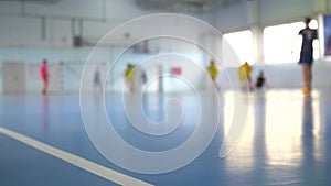 Football futsal training for children. Indoor soccer young player with a soccer ball in a sports hall.