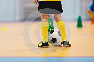 Indoor european football background. Close-up of futsal player. Football futsal training for children