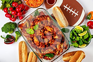 Football game party includes wings, dip sauce and salad.