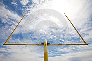 Football goal posts - whispy white clouds blue sky