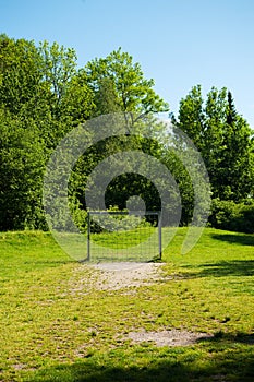 Football ground, soccer field with chain goals in the nature for the youth, summer time