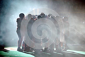 Football Huddle in fog