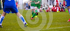 Football kick. Soccer ball in motion. Young soccer player