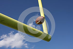 Football kicked through the uprights