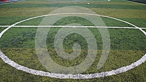 Football lined green grass field at kick off
