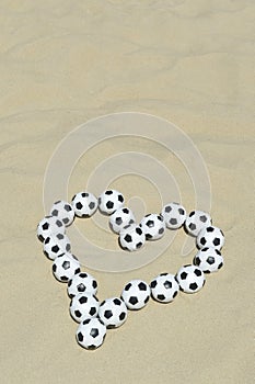 Football Love Heart Made with Soccer Balls on Beach