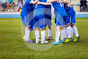 Football match for children. Youth sports team celebrate.