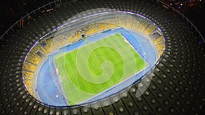 Football match on large stadium field, vertical aerial view, 4k