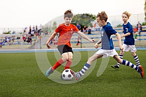 Football match between youth soccer teams. School boys playing soccer game