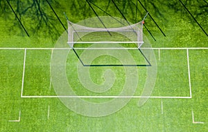 Football net on the background of a green football field. Aerial view of football gate