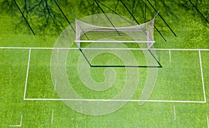 Football net on the background of a green football field. Aerial view of football gate