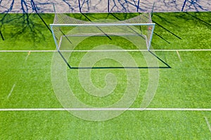 Football net on the background of a green football field. Aerial view of football gate