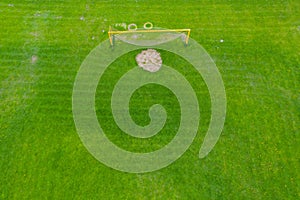 Football net on the background of a green football field. Aerial view of football gate