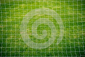 Football net on green grass football field