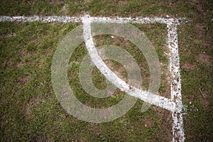 Football pitch markings at corner on muddy pitch