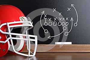 Football play strategy drawn out on a chalk board