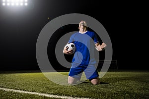 Football player celebrating goal in the stadium