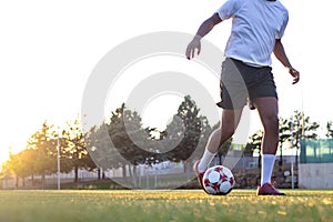 Football player on the field running with the ball. Close up of player\'s feet running with the ball on the field.