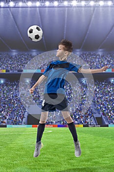 Football player hitting the ball with head on a soccer stadium