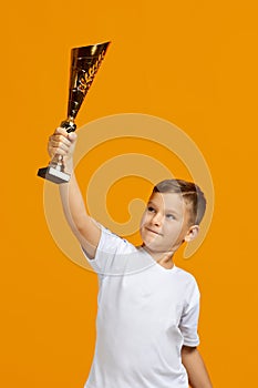 Football player holding a golden cup