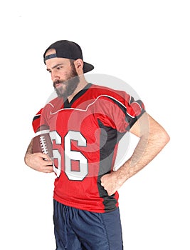 Football player holding his ball and relaxing