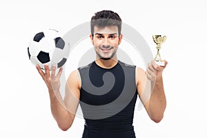 Football player holding winners cup
