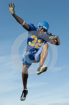 Football player jumping with ball