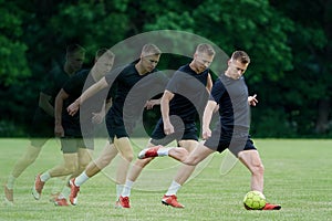 Football player kicking a ball in multiple exposures