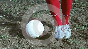 Football player on a muddy pitch,slow motion dribbling