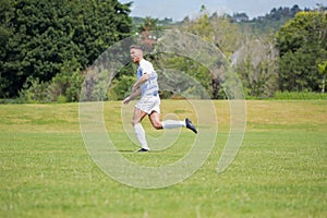 Football player playing soccer in the ground