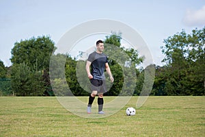 Football player playing soccer in the ground