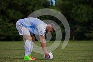Football player ready to kick the soccer ball