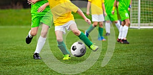 Football Player Running with the Ball on the Pitch. Young Footballers