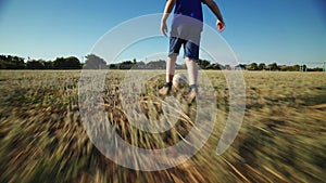 The football player scores the ball into the goal. The boy kicks the ball.