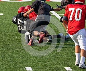 Football player tackled on field during game -American football