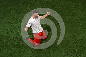 Football player tackling ball over green grass background