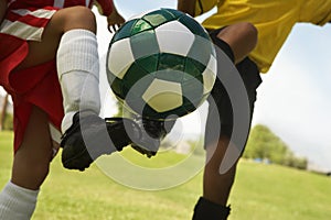 Football Player Tackling Soccer Ball