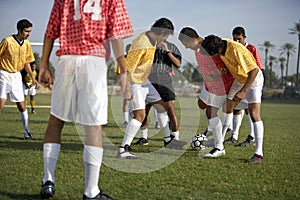 Football players around ball