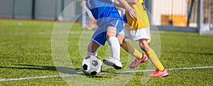 Football Players Compete For a Ball. Children Playing Sports on Grass Pitch