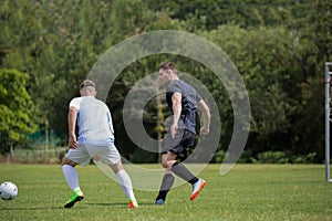 Football players playing soccer in the ground