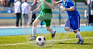 Football Players in Running Duel. Forward and Defense Player Compete for the Ball