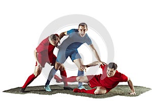 Football players tackling for the ball over white background