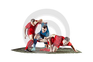 Football players tackling for the ball over white background