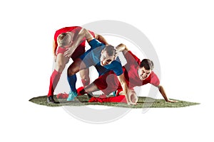Football players tackling for the ball over white background